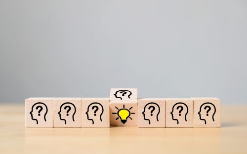 Concept creative idea and innovation. Wooden cube block flip over with head human symbol and light bulb icon